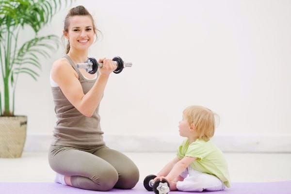 mom doing exercises next to her daughter