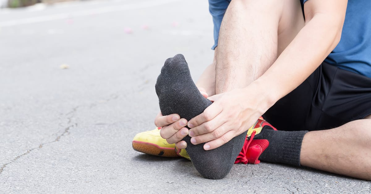Runner clutching foot in pain