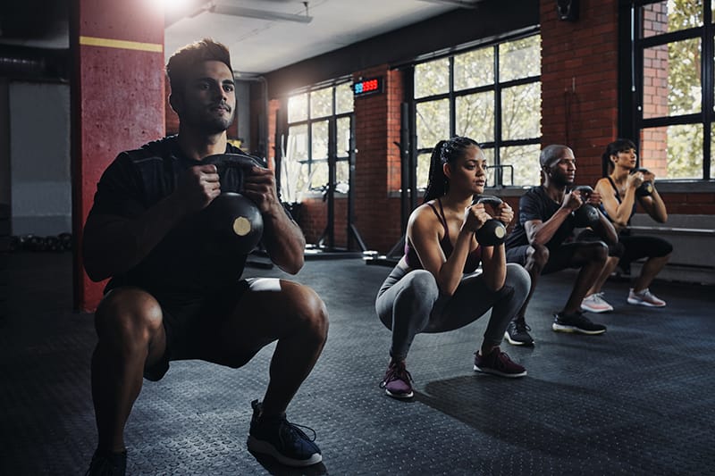 group of people doing squats