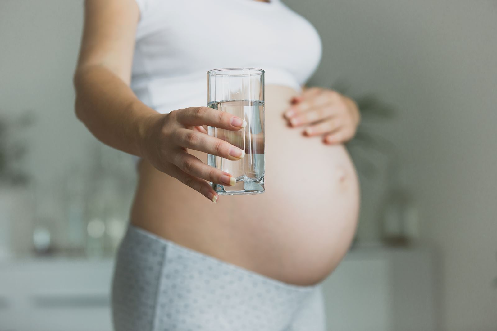 Pregnant woman holding water