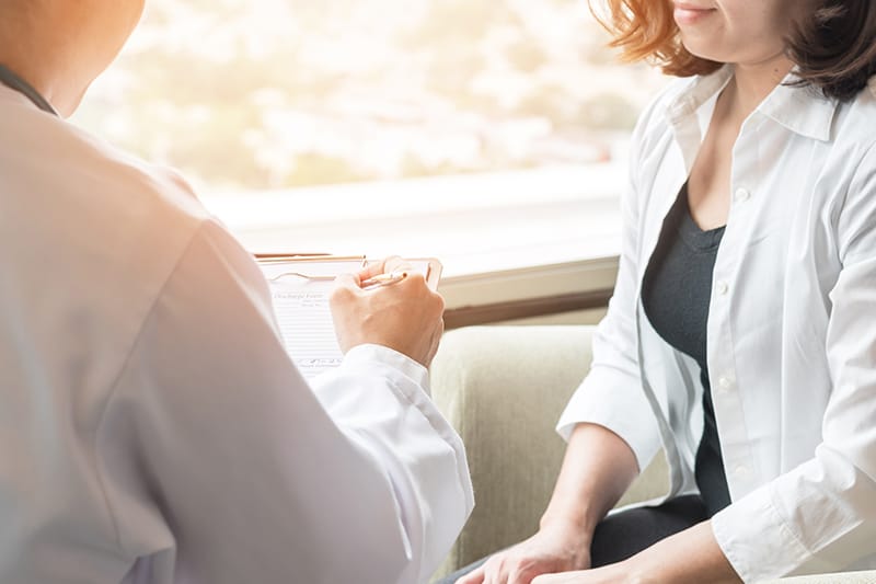 Doctor reviewing chart with patient