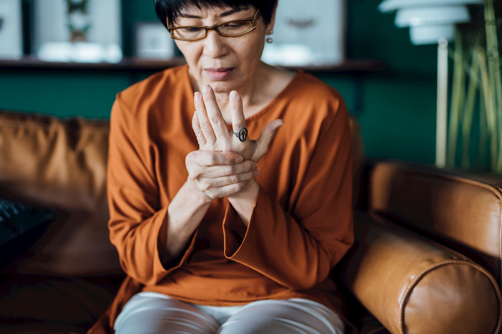 woman rubbing hand in pain