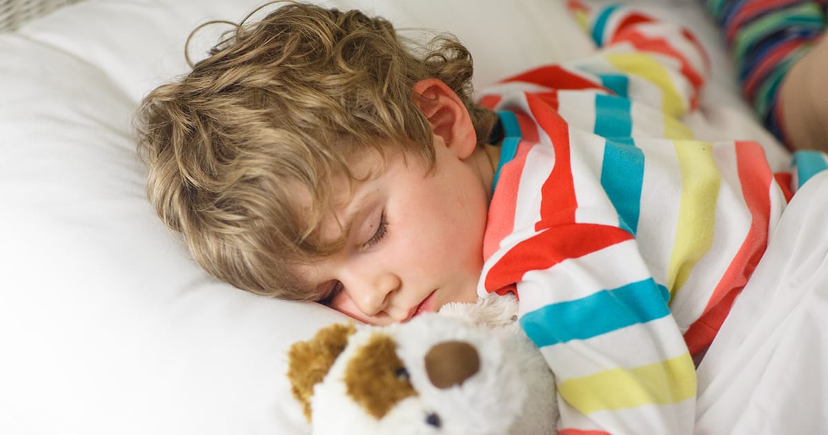 toddler boy sleeping with stuffed animal
