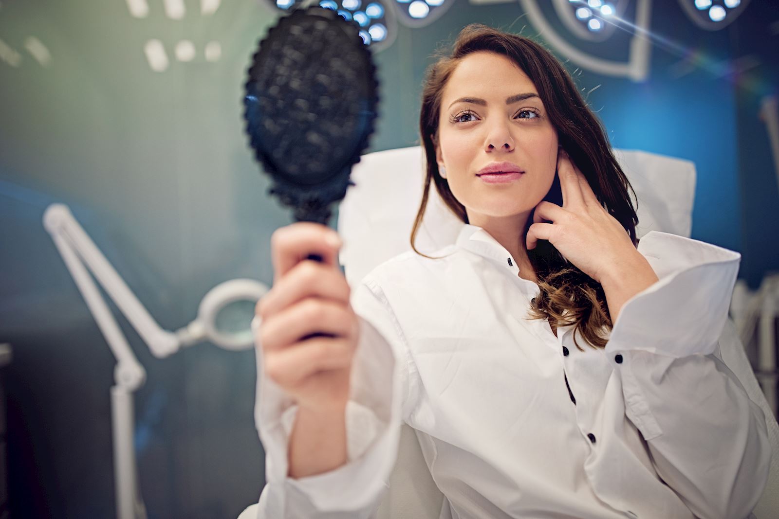 woman looking at herself in the mirror