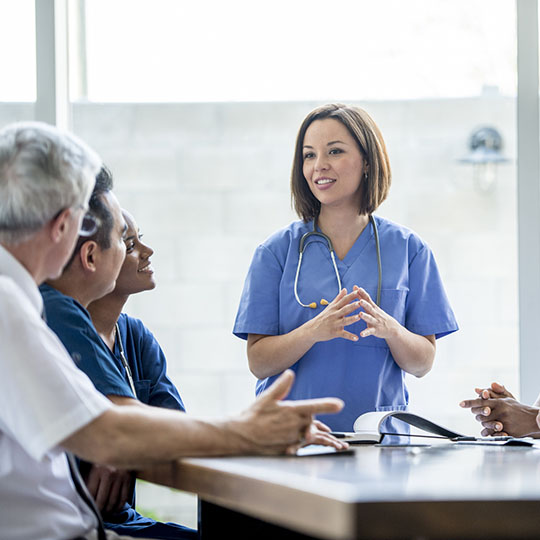 Doctor talking to other doctors