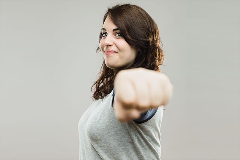 women giving viewer fist bump in solidarity