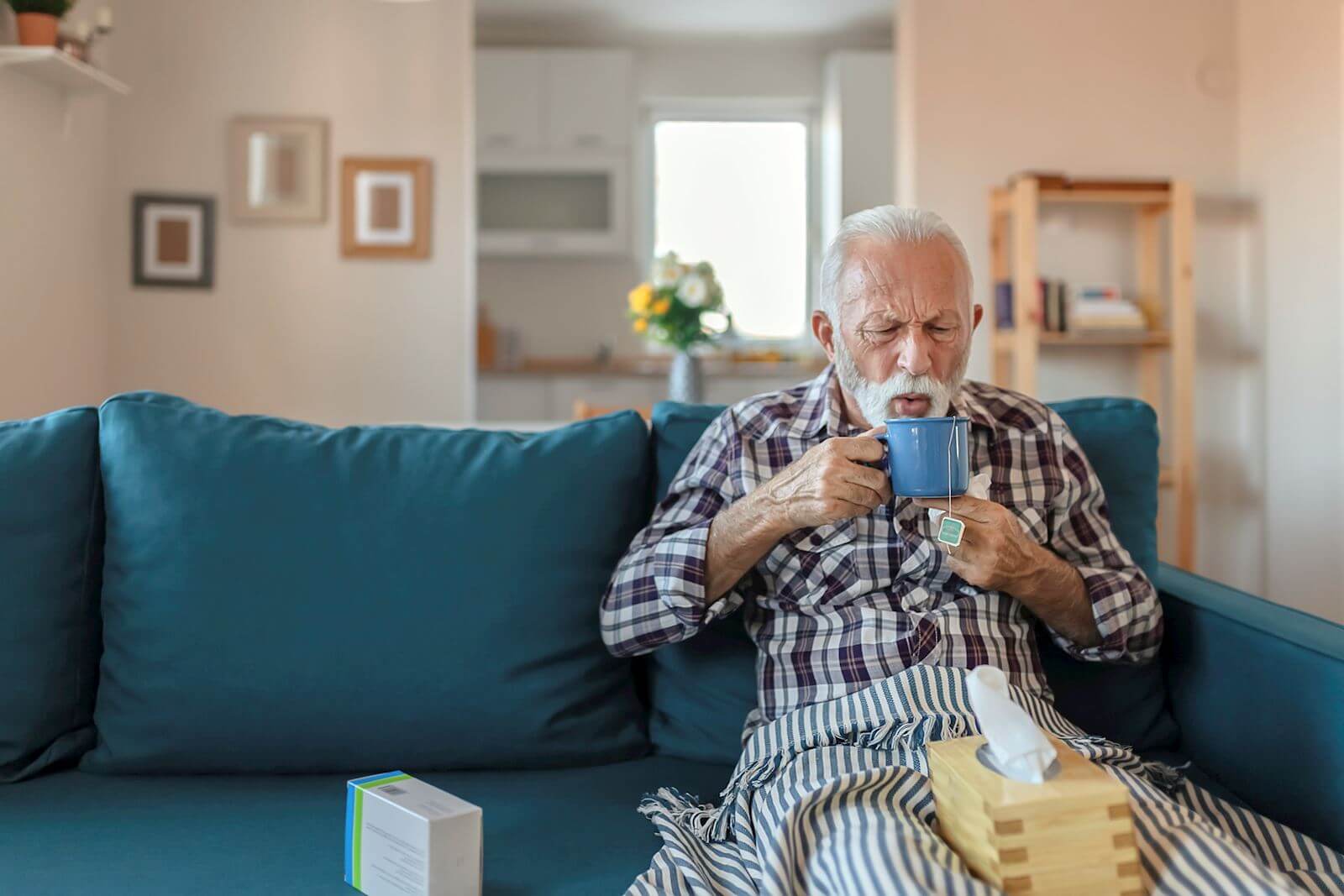 man cooling down his tea