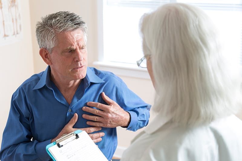 man talking to doctor talking about his chest