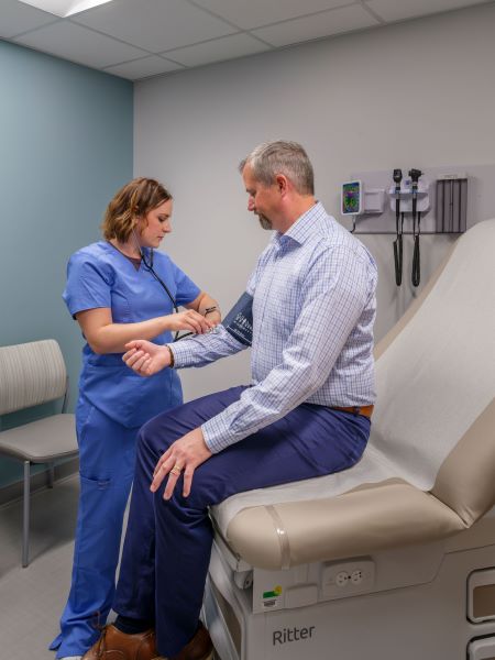 Doctor checking patients blood pressure