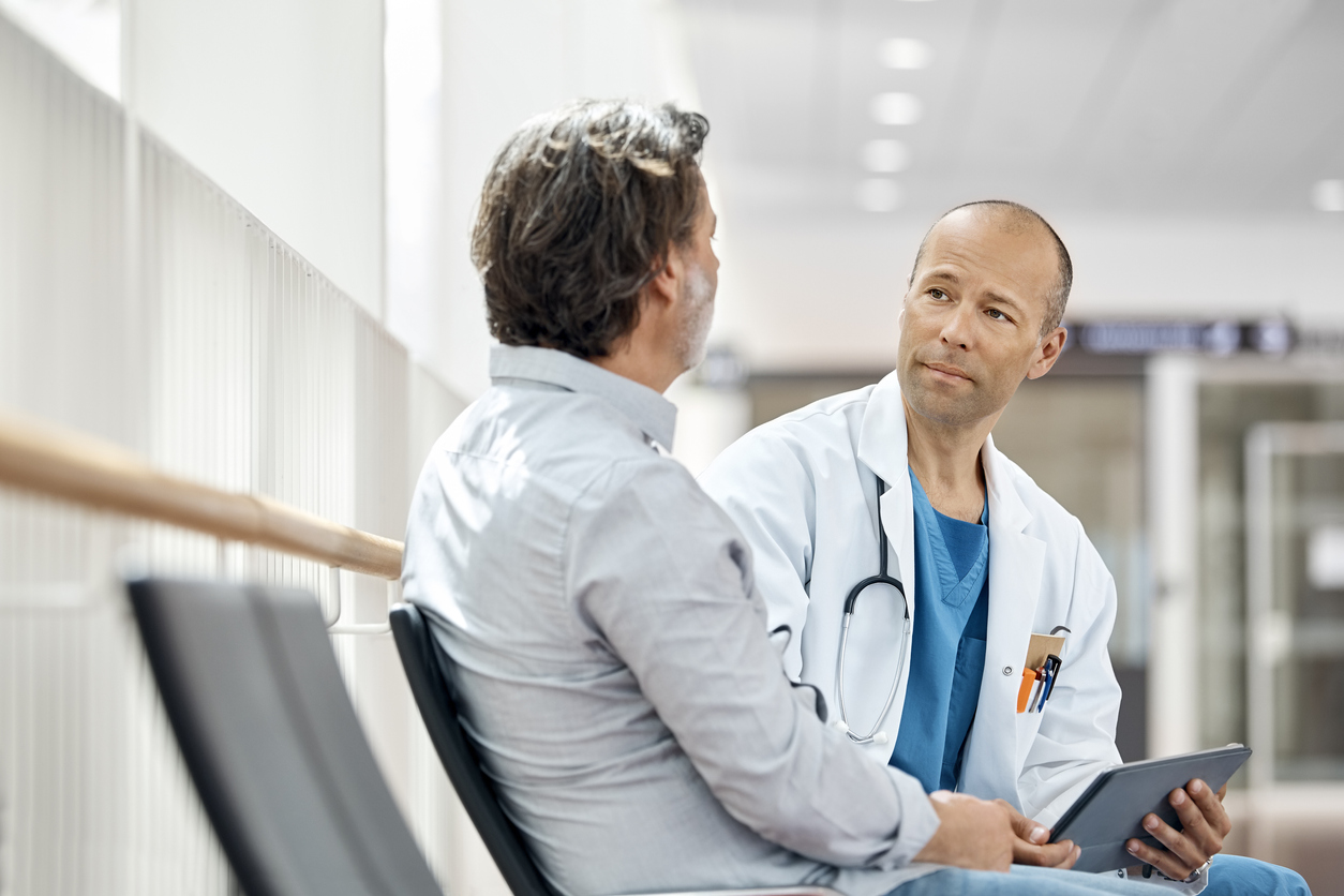 doctor talks with man