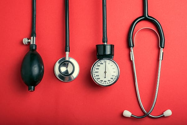 still image of stethoscope and blood pressure gauge on red background