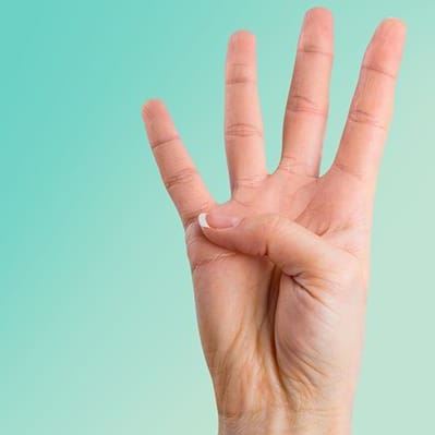 person holding up four fingers