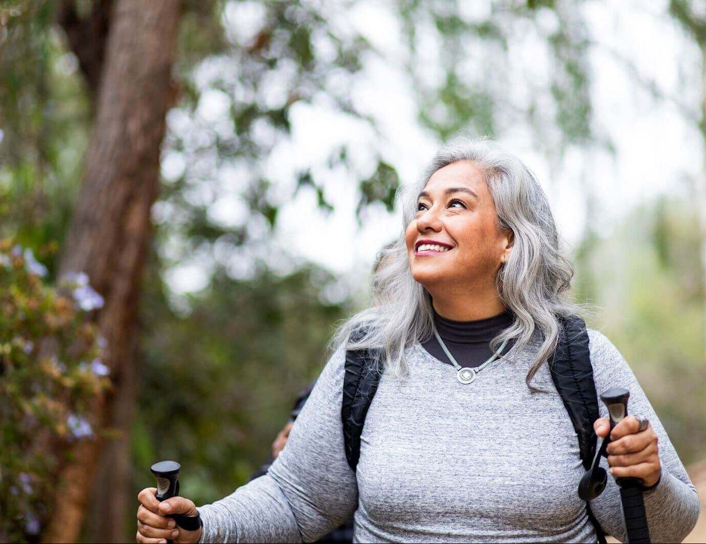 woman enjoying a hike through woods