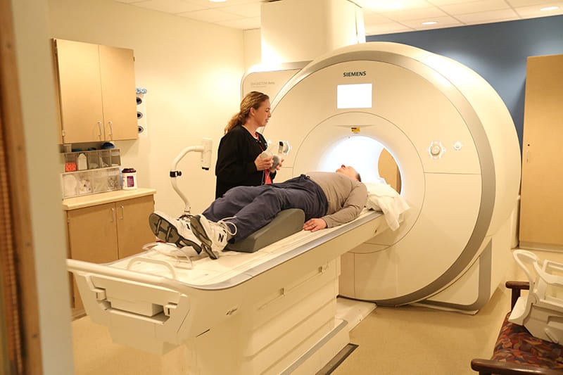 person laying on mri machine bed