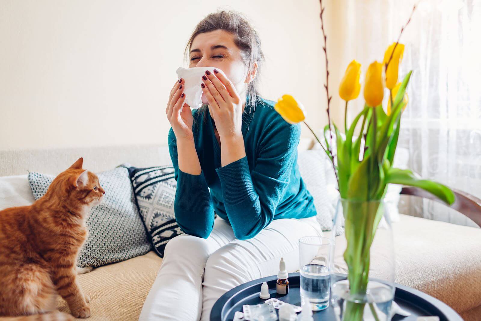 woman sneezes into tissue