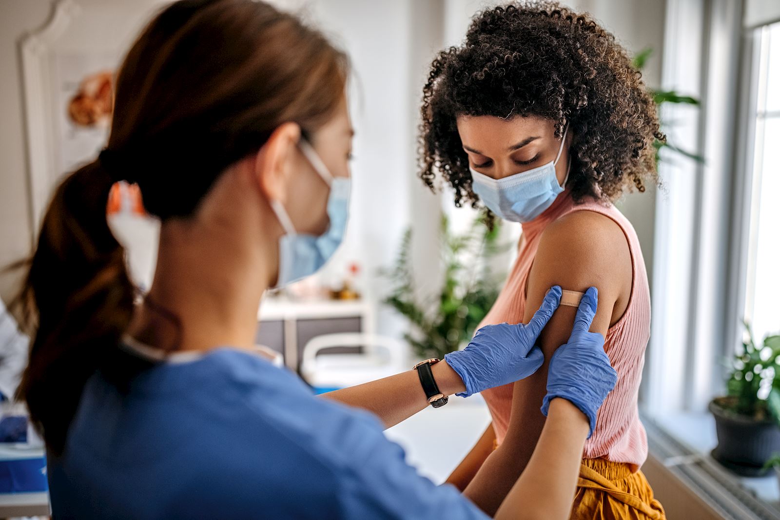 nurse applies bandage to patient
