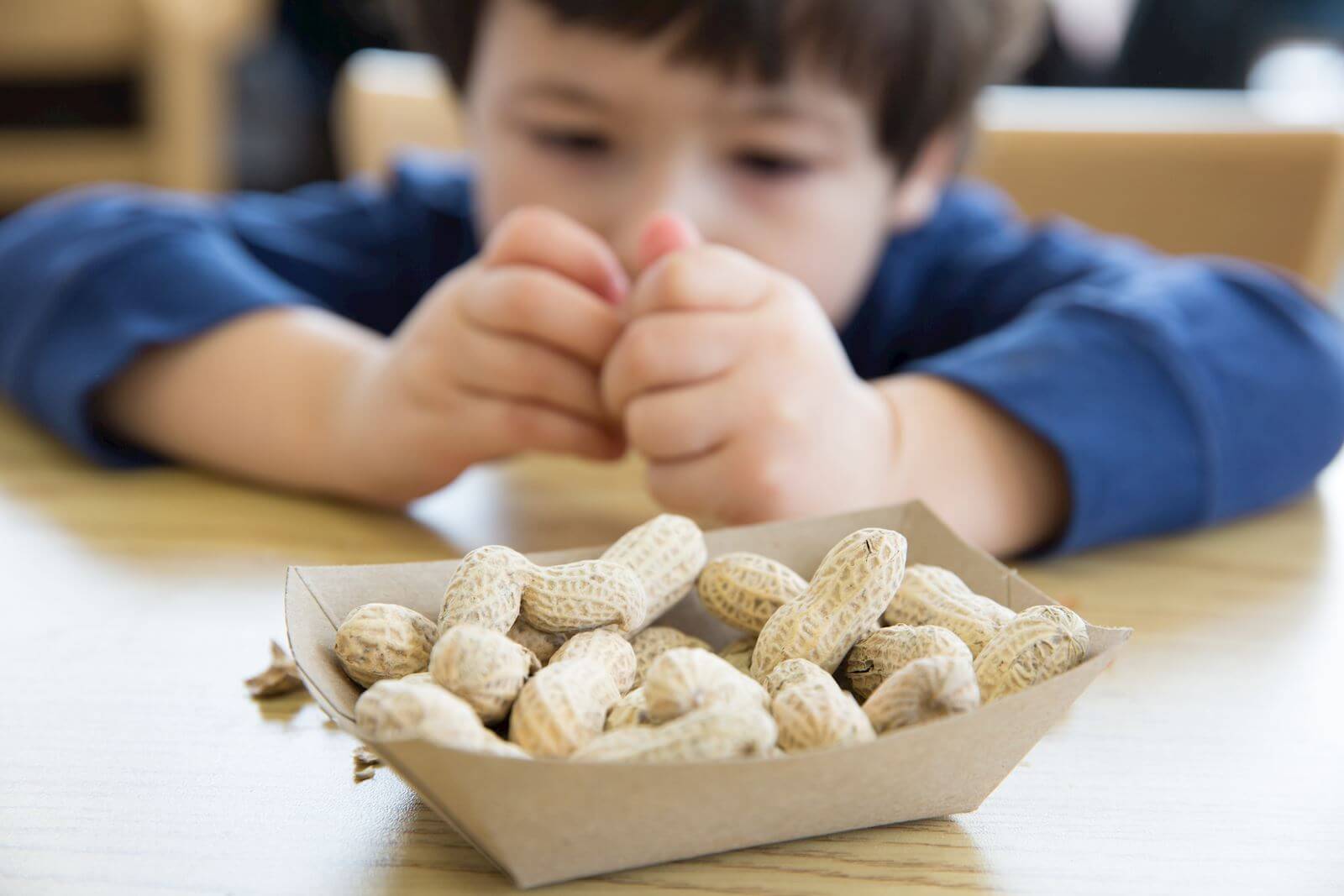 boy plays with peanuts