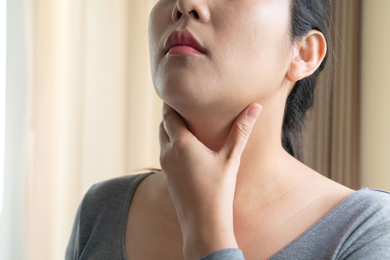 woman rubbing neck