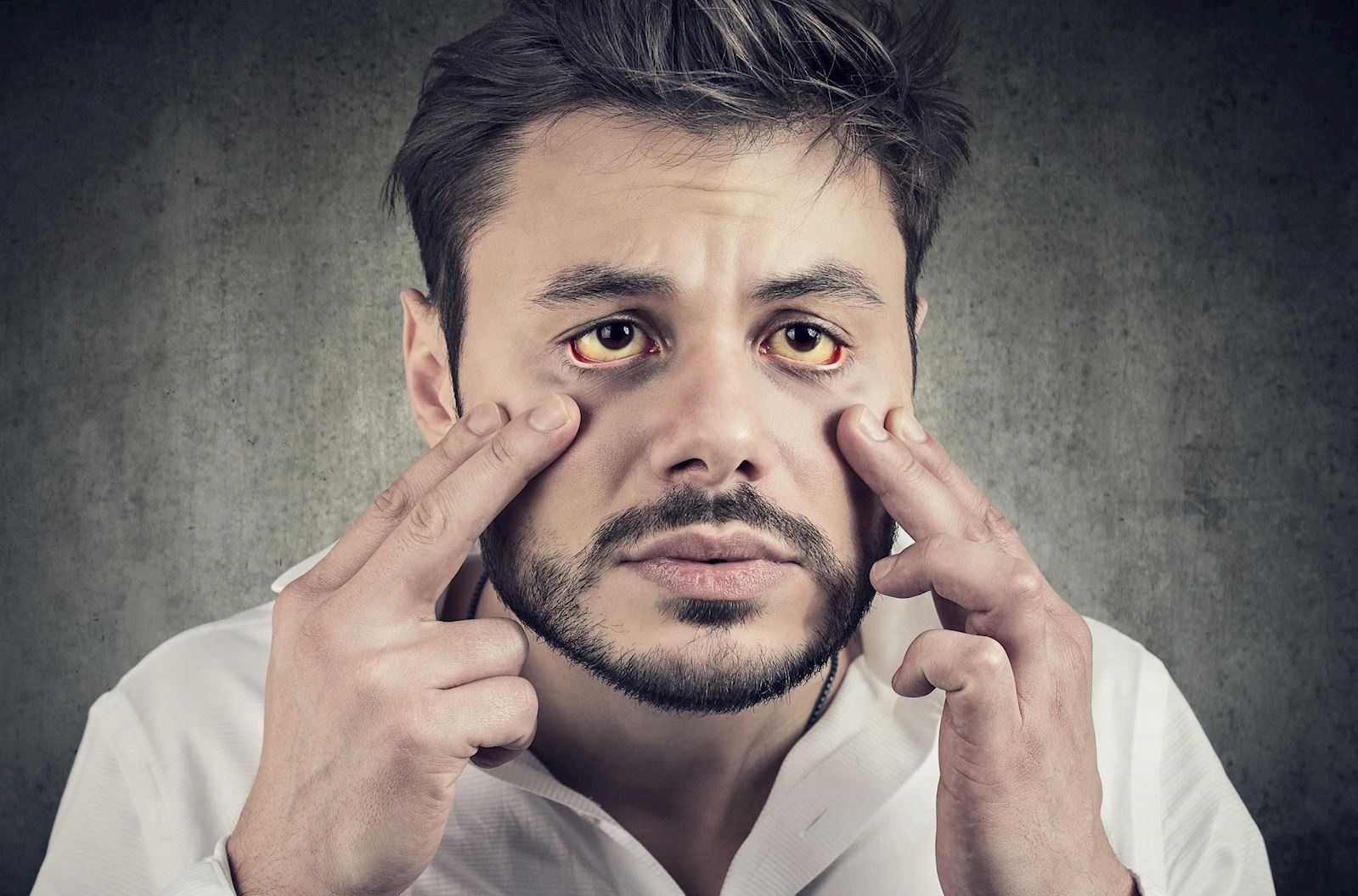 sickly man looks in mirror