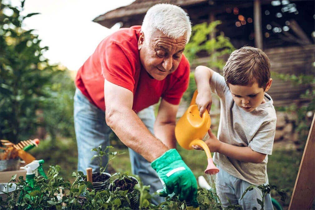 old man and young boy garden together