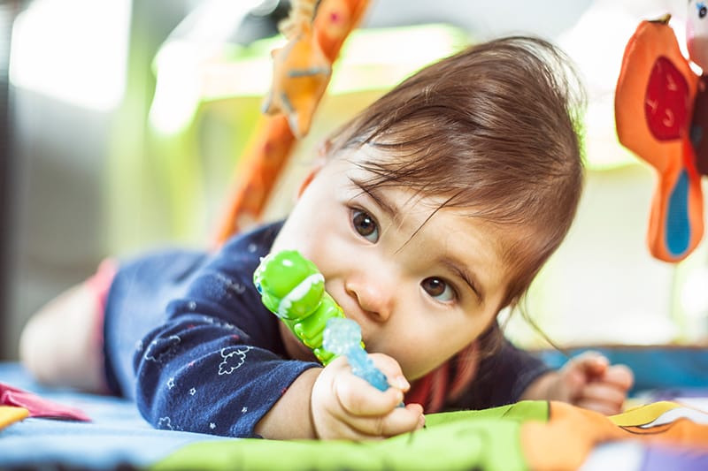 baby teething on teething ring