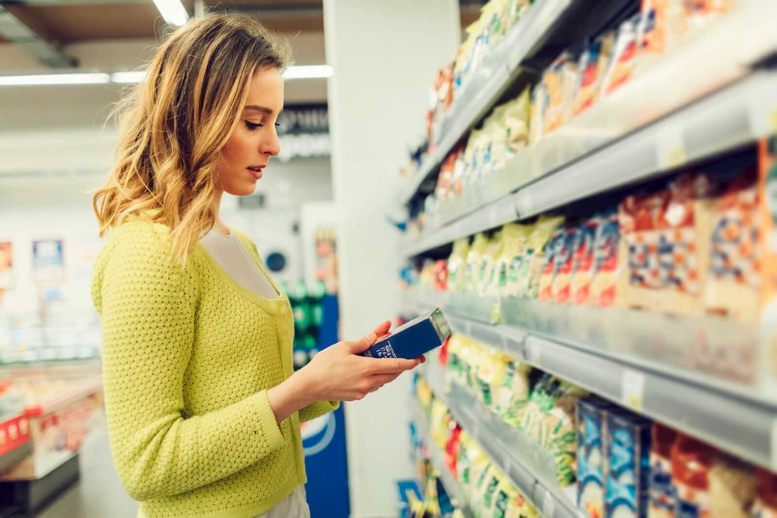 woman reading food allergy label