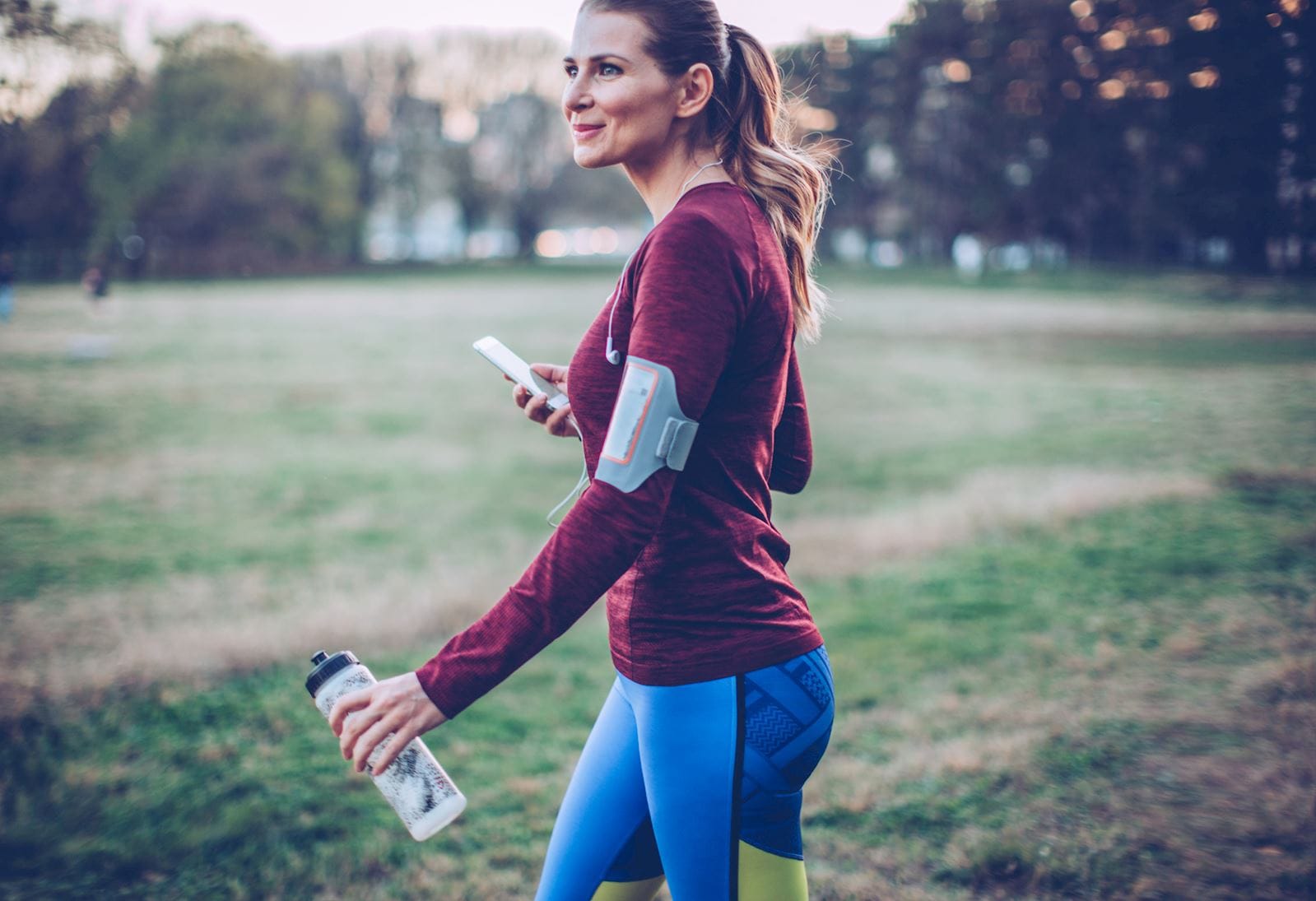 woman walking with water bottle