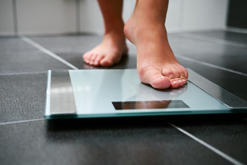 person stepping on a scale