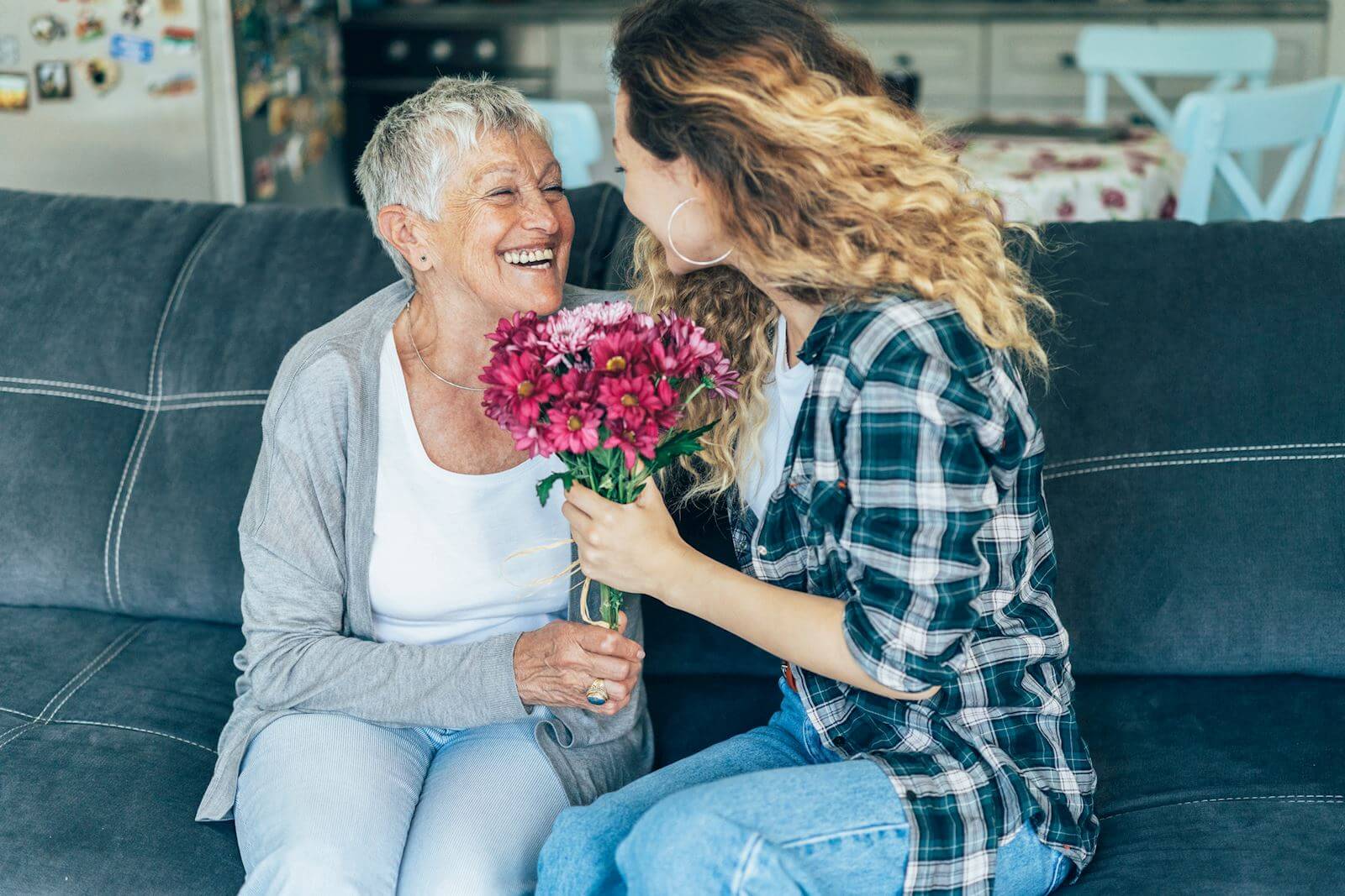 Daughter handing her mother flowers