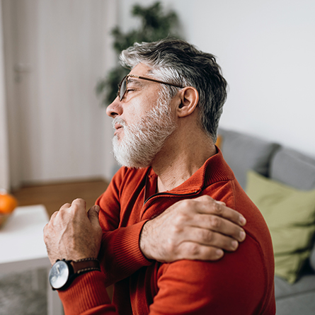 Man holding his shoulder in pain