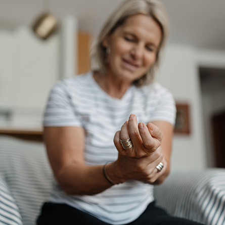Woman holding her hand in pain