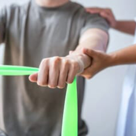 Patient doing PT exercises with a band between his hands