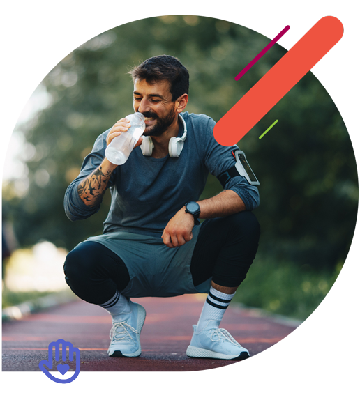 Man drinking water on a running track