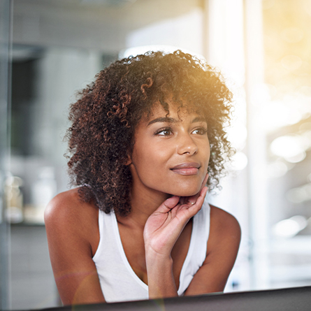 woman admires skin in mirror