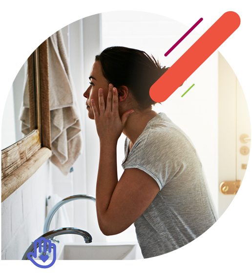 Woman checking her face in the mirror