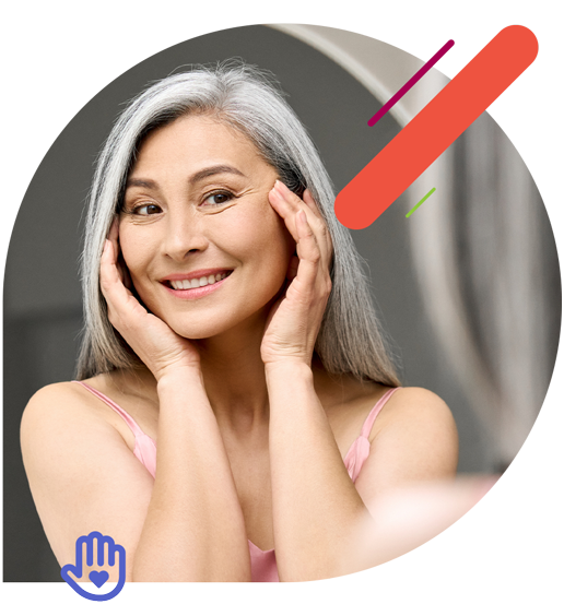 Woman holding her face and smiling in a mirror