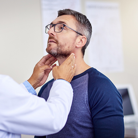 doctor checking man's esophagus