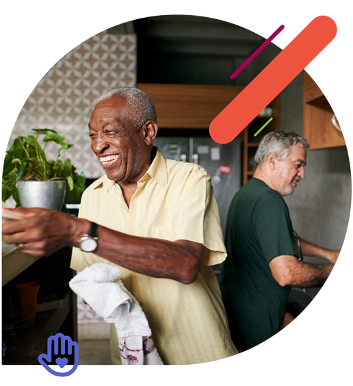 Man smiling and drying a dish in the kitchen