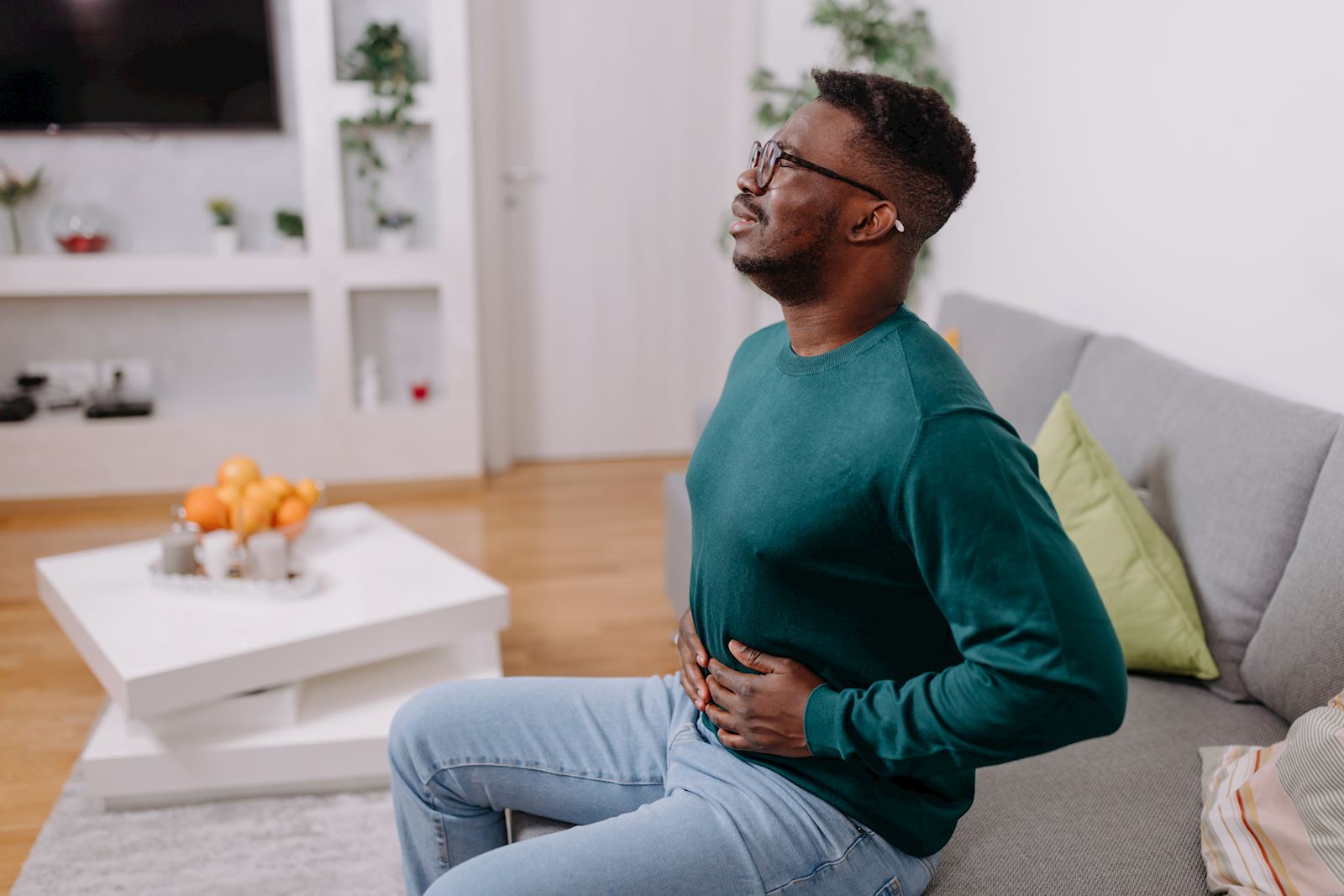 man holding stomach in pain