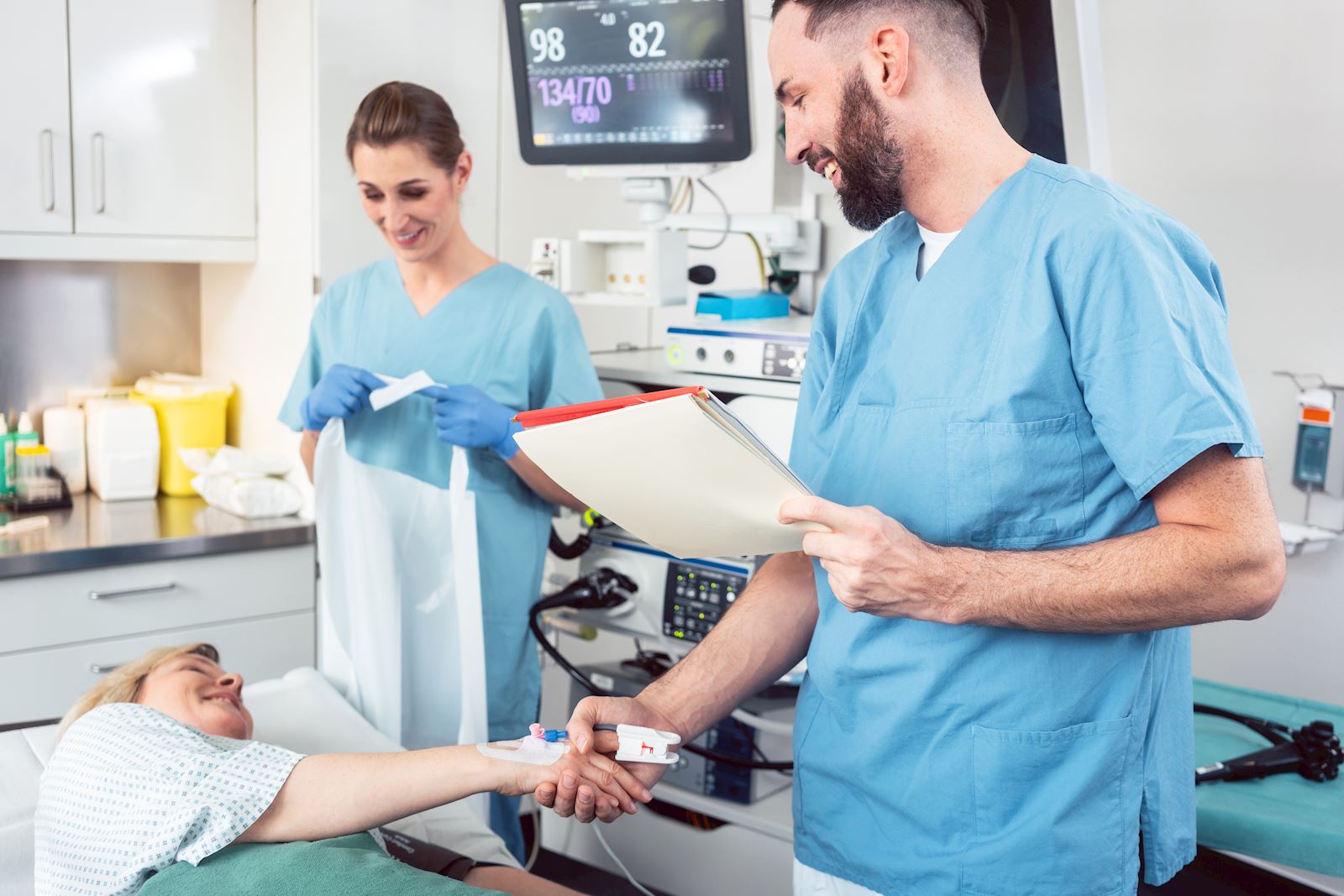 Healthcare providers meet with patient before procedure