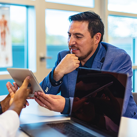 businessman checks options on tablet