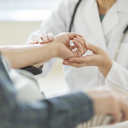 Doctor checking a patients hand