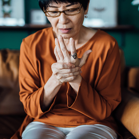 Woman holding her hand in pain