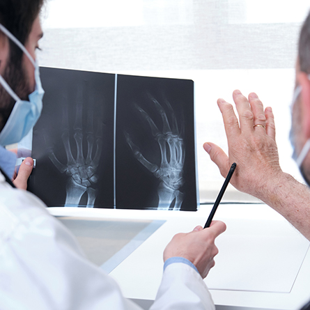 Doctor looking at x-ray of patients hand