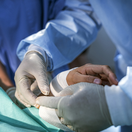 Doctor performing hand surgery