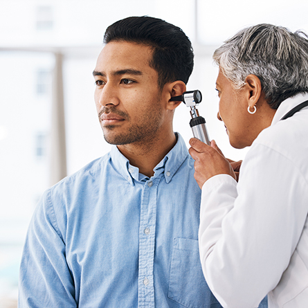doctor reviews man's ear