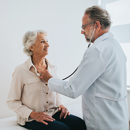 Doctor checking patients' heart with stethoscope