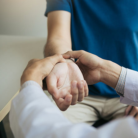Doctor feeling a patients' wrist