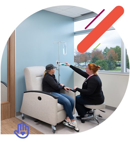Nurse helping patient in the infusion center
