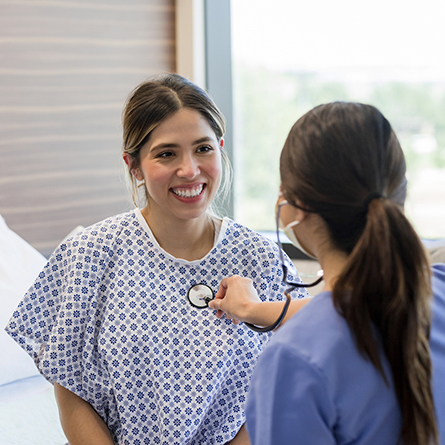 Doctor checking patients' heart with stethoscope